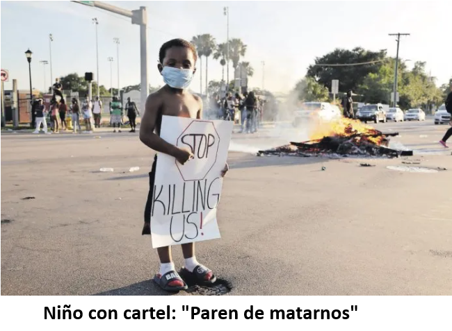 Niño con cartel Paren de matarnos